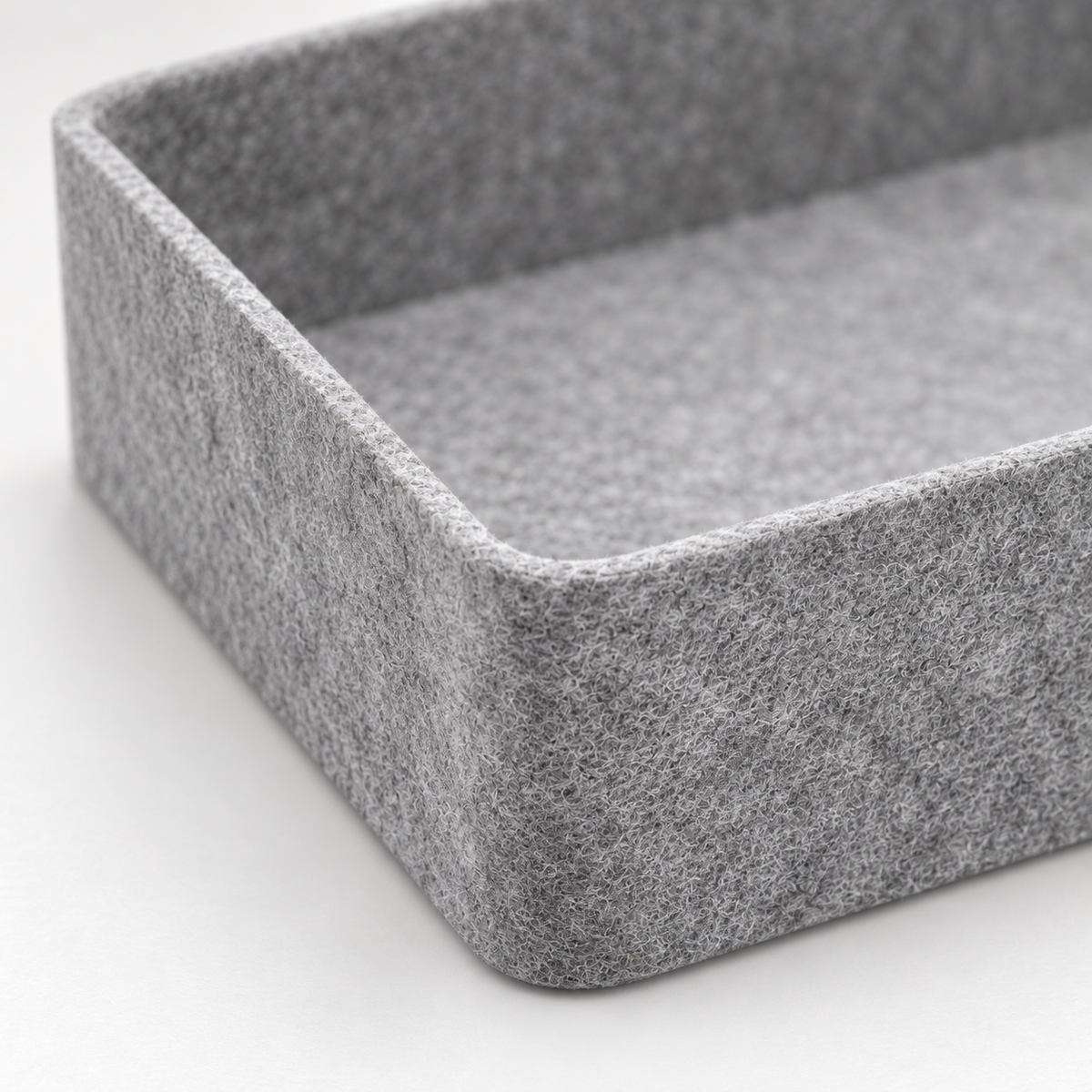 Close-up of gray polyester felt and formed tray edge